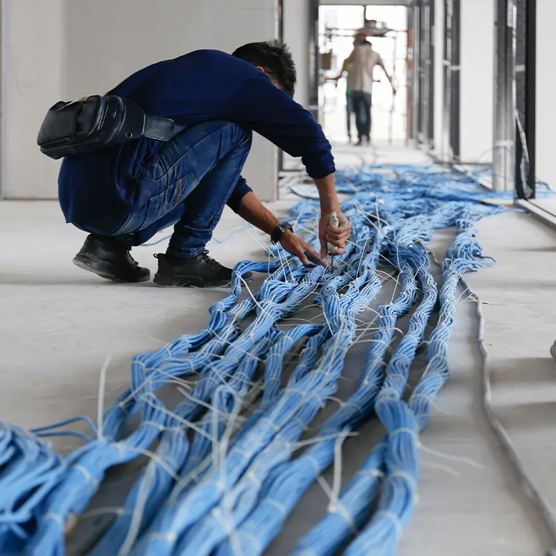 Technician sorting bundles of network cable during installation